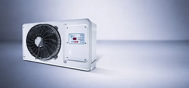 Close-up of a wall-mounted refrigeration unit with a large fan and digital control panel on the front.
