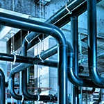 An image of alot of pipes running through a room