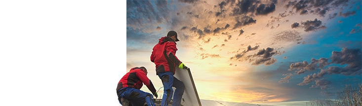 Renewables life style image, 2 men setting up a slar panel as the sun rises