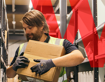 Wolseley warehouse colleague carrying a parcel